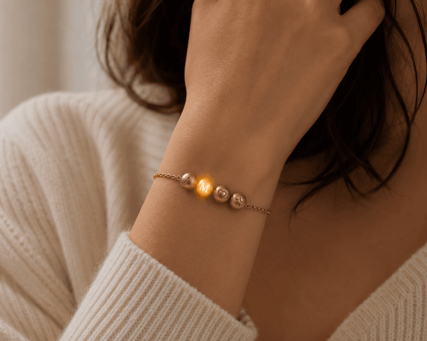 A Lumheart bracelet worn — one bead glowing warm amber, a glow received from across the world